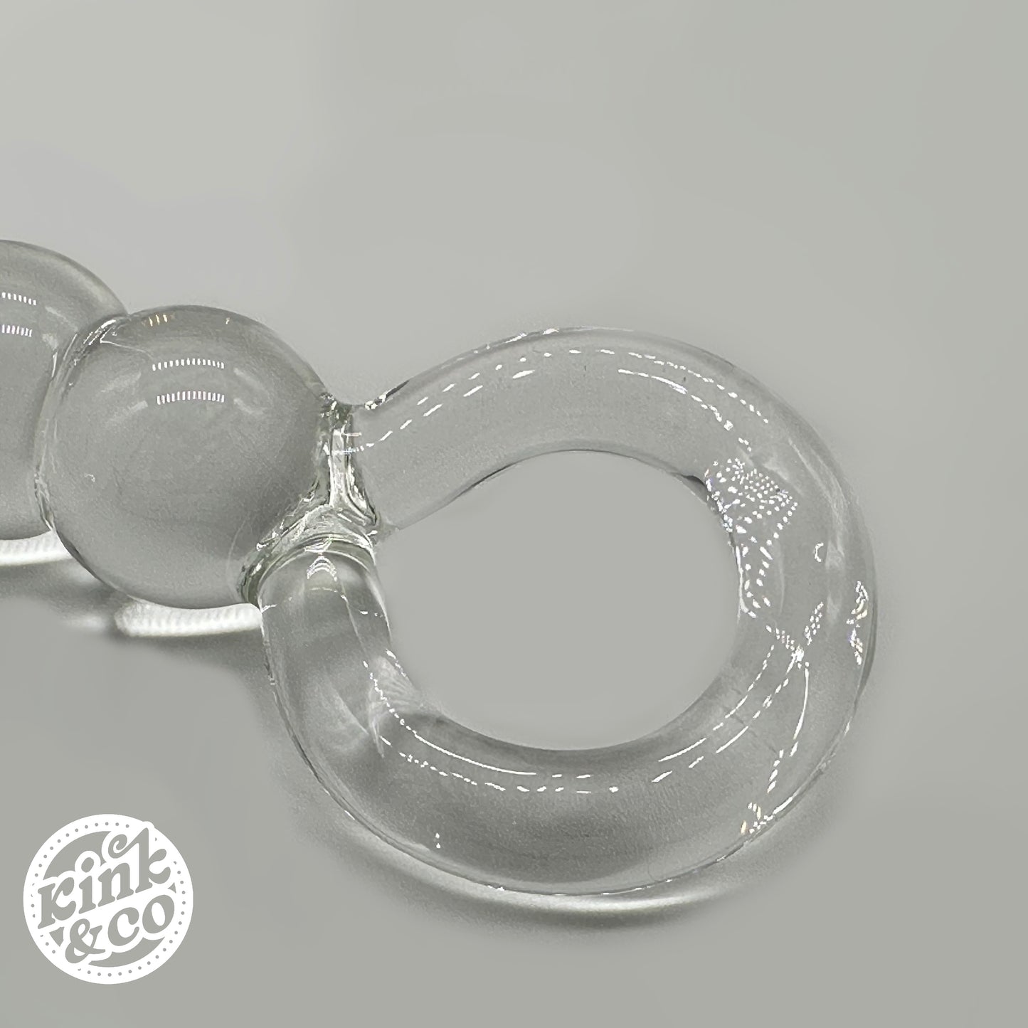 Top of clear Glass anal beads with O ring Handle - By Kink&Co