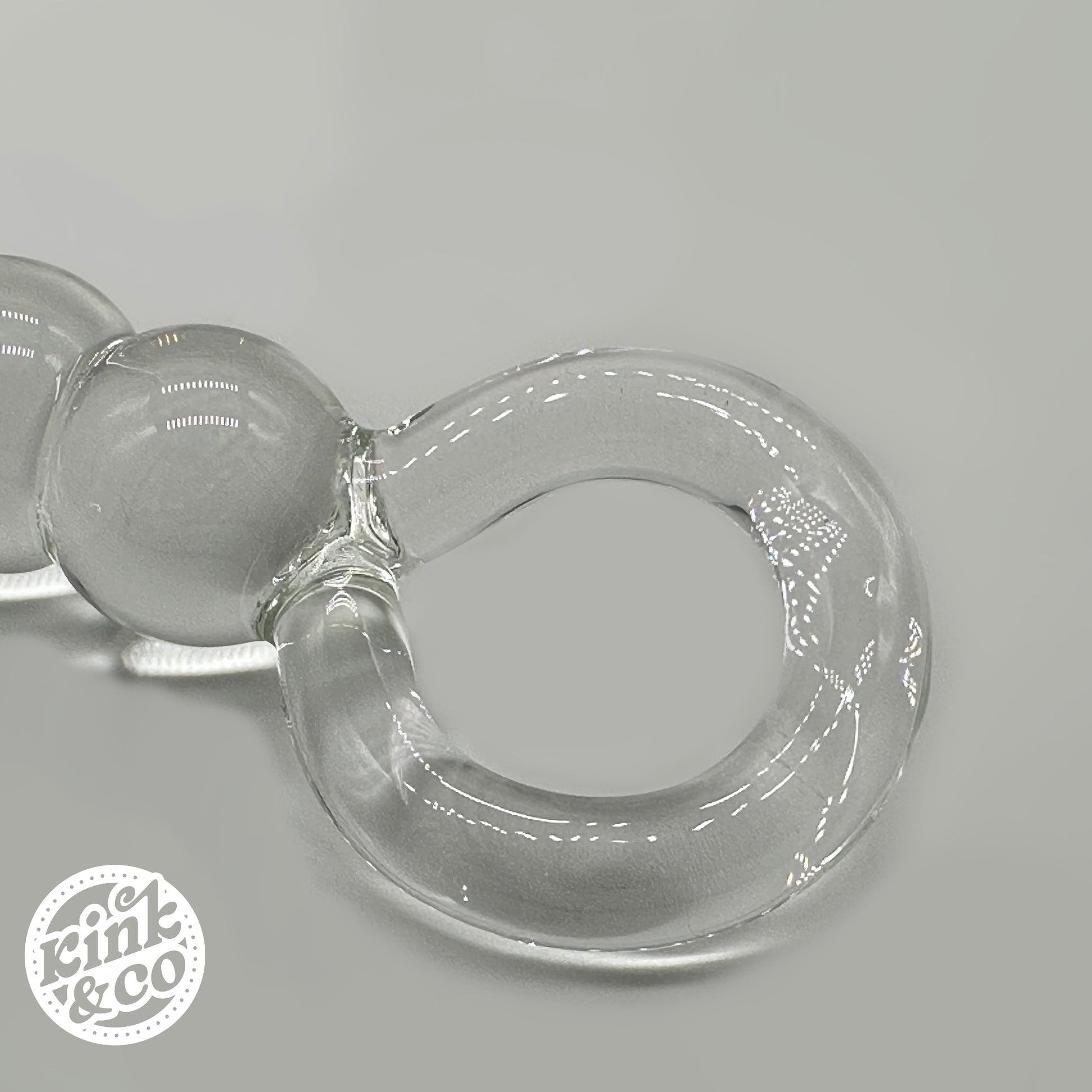 Top of clear Glass anal beads with O ring Handle - By Kink&Co