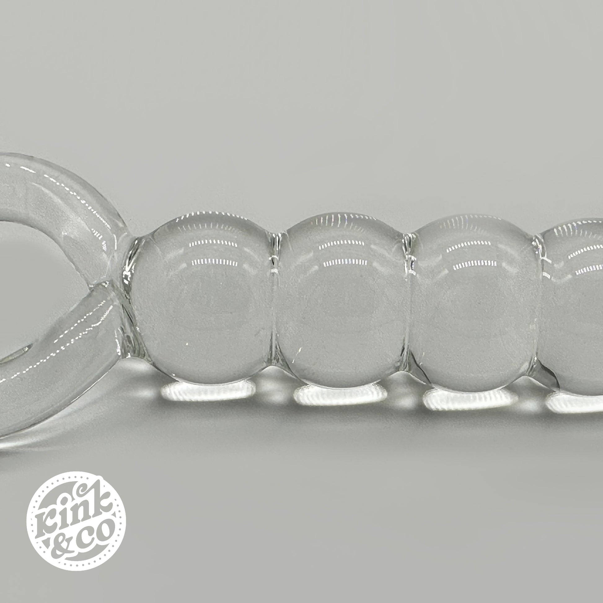 Side of Glass anal beads with O ring Handle - By Kink&Co