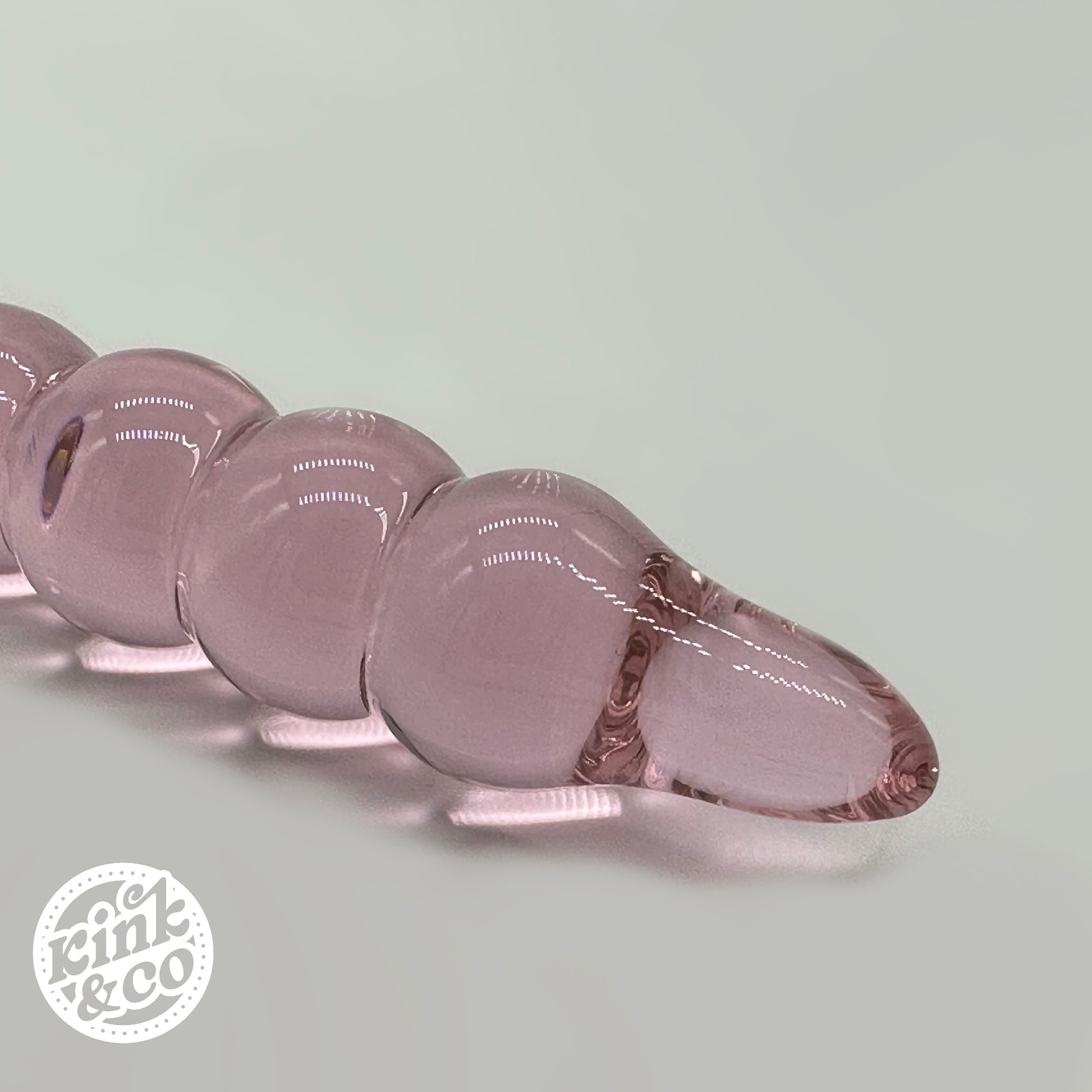 Tip of pink Glass anal beads with O ring Handle - By Kink&Co